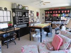 a living room filled with furniture and lots of shelves