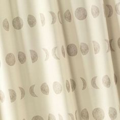 a white curtain with grey circles on it