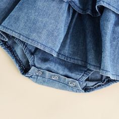 This smocked denim romper is beautifully designed with layered ruffles and comes with snaps at the bottom for quick and easy changing. A absolute must for this summer! Casual Ruffled Bottoms For Playtime, Cute Denim Bottoms With Ruffles, Cotton Bubble Romper With Ruffles For Playtime, Spring Ruffled Bottoms For Playtime, Summer Denim Jumpsuit With Ruffles, Spring Playtime Ruffled Bottoms, Casual Bubble Romper With Ruffles For Playtime, Ruffled Bottoms For Summer Playtime, Blue Cotton Bubble Romper With Ruffles