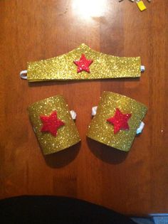 two pieces of gold glitter with red stars on them