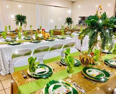 the tables are set with green and gold plates, napkins, and centerpieces