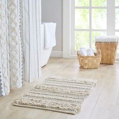 a bathroom with white walls and wooden floors