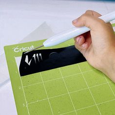 a person is cutting up a piece of paper with a sharpie on the edge