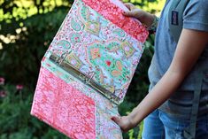 a woman is holding a binder in her hand