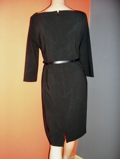 "Vintage 90s, Arthur Levine, 50s style, black belted dress, drape neckline, 3/4 sleeves. Back zip. Size 4. Fully lined. 64% poly, 33% rayon, 3% spandex. Lining is 100% poly. Mint condition, no flaws or damage. Measurements: shoulders across front: 17\" chest across front: 17\" waist across front: 14\" hips across front: 18\" sleeve inseam: 12\" (3/4 sleeve) length: 38\" Please keep in mind that vintage sizes are very often much smaller than contemporary ones. The best way to know if a garment wi Black Long Sleeve Belted Dress For Formal Occasions, Fitted Black Belted Dress For Evening, Fitted Black Belted Dress For Work, Black Knee-length Belted Dress For Formal Occasions, Formal Black Knee-length Belted Dress, Dress Drape, 50s Style, 50 Style, 50s Fashion