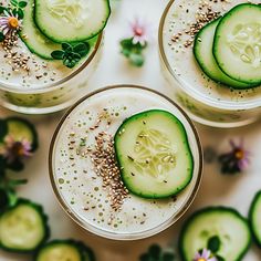 three glasses filled with cucumbers and sprinkles on top of a table