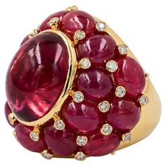 Sophia D. cocktail ring set in 18K yellow gold that features a 25.06 carat ruby, 13.62 carat tourmaline and 0.41 carat diamond. Sophia D has been known world-wide for over 40 years because of its rich history of design and quality craftsmanship. From art deco to antique reproduction, these timeless pieces, when merged with modern manufacturing techniques, create a perfect harmony between old and new. Exquisite Round Ruby Jewelry, Luxury Multi-stone Round Cut Ruby Ring, Luxury Fine Jewelry Ruby Ring With Cabochon, Ruby Tourmaline, Exquisite Luxury Multi-stone Ruby Ring, Antique Ruby Multi-stone Jewelry, Ruby Jewel, Diamond Cocktail Ring, Special Ring