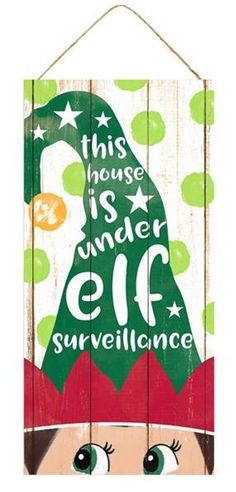 a wooden sign with an elf's hat on it that says, this house is under eif surveillance