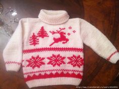 a white and red sweater sitting on top of a table