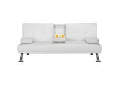 a white couch with two candles on the back and one candle holder in the middle