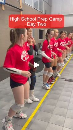 a group of girls in red shirts holding tennis racquets