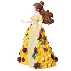 a figurine of a woman in a yellow dress with roses on the skirt