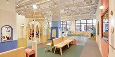 the interior of a children's playroom with colorful furniture