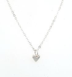 "This is a tiny tiny little heart charm made out of solid sterling silver. It is perfect for layering with other necklaces, or wear it on it's own for a nice and simple necklace. It's perfect for a discrete and minimalist everyday necklace :) The photo on the neck form shows the charm on a 16\" chain, however you can chose between 16\", 18\", or 20\". I make all of my jewelry by hand in my Savannah, GA studio. Please contact me if you have any questions :)" Minimalist Nickel-free Heart Pendant Jewelry, Minimalist Nickel-free Heart-shaped Jewelry, Minimalist Heart-shaped Nickel-free Jewelry, Minimalist Heart Shaped Nickel-free Jewelry, Minimalist Nickel-free Heart Jewelry, Minimalist Nickel-free Heart Pendant Necklace, Minimalist Hypoallergenic Heart Pendant Jewelry, Dainty Everyday Heart Charm Necklace, Tiny Heart Pendant Charm Necklace For Everyday