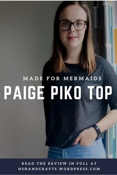 a woman wearing glasses standing in front of a wall with the words made for mermaids pagie piko top