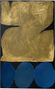 an abstract painting with gold and blue circles on black paper, against a dark background