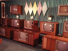 a room filled with lots of old fashioned tvs