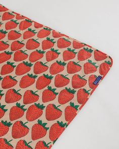 a close up of a cloth with strawberries on it