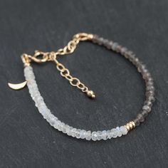 Beautiful AAA grey & white moonstone bracelet   D E T A I L S △ Handmade in Vancouver △White Moonstone & Grey Moonstone △ Sterling Silver accents & clasp OPTIONAL △ 14K Gold filled findings OPTIONAL △ Gold vermeil crescent moon OPTIONAL △ Extender for perfect fit (6-8") △ Gemstones are 100% genuine  G E M S T O N E I N FO  Moonstone: intuition, inspiration, abundance L E N G T H 6-8" ♡ Q U A L I T Y  The upmost quality and care goes into sourcing each and every material I use. Gemstones are sour Luxury Moonstone Gemstone Bracelets, Gold Bracelet Moonstone, Minimalist Handmade Moonstone Beaded Bracelets, Handmade Minimalist Moonstone Beaded Bracelet, Minimalist Handmade Beaded Bracelet With Moonstone, Minimalist Handmade Moonstone Beaded Bracelet, Handmade Dainty Moonstone Beaded Bracelets, Moon Stone Bracelet, Grey Moonstone