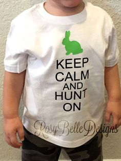 a toddler wearing a t - shirt that says keep calm and hunt on with a green bunny