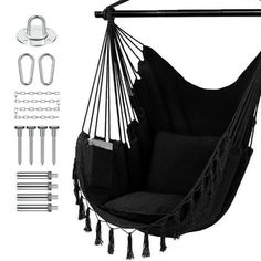 a black hammock chair hanging from a metal bar with hooks and clips to hang it