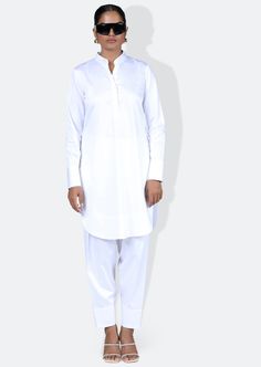 The giza set is inspired from our traditional salwar and kurta , it has a mandarin collar with an opening in the center front . It is made in light weight giza cotton with elasticated bottoms cut in a relaxed fit. Traditional Dabka Kurta For Work, Traditional Cotton Lawn Suit For Work, Cotton Kurta For Work And Eid, Elegant Cotton Kurta For Workwear, White Kurta For Eid Workwear, White Kurta For Workwear And Eid, Cotton Kurta With Stand Collar For Eid, Eid Cotton Kurta With Stand Collar, Elegant White Straight Kurta Kaftan