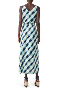 Move gracefully in this sleeveless dress designed in an eye-catching plaid print and tethered with a defining waist tie. 48" length Slips on over head Scoop neck Sleeveless Removable tie belt Lined 100% polyester Machine wash, tumble dry Imported Spring Gingham Sleeveless Maxi Dress, Sleeveless Gingham Dress For Vacation, Plaid Maxi Dress For Summer Beach, Summer Plaid Maxi Dress, Sleeveless Gingham Beach Dress, Spring Sleeveless Plaid Dress, Chic Sleeveless Gingham Dress, Sleeveless Plaid Spring Dress, Summer Vacation Plaid Sleeveless Dress