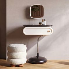 a white sink sitting on top of a wooden floor next to a mirror and stool