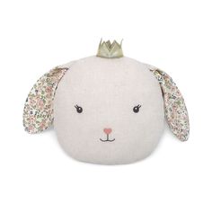 a white stuffed animal with a crown on top of it's head and ears