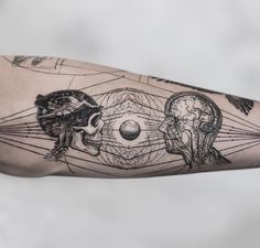 a person's arm with tattoos on it and an image of a skull in the middle