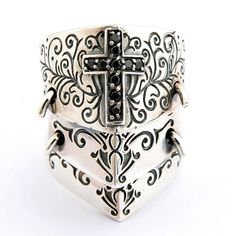 Black Cross 925 Sterling Silver Medieval Armor Rocker Ring ~NEW 100% polished solid sterling silver Stamp .925 trademark inside the band Solid sterling silver weight: 16g Ring face measures: 22mm x 31mm A medieval ring for a medieval man! If you feel as though you were born in the wrong era, you will love this unique double ring design. Featuring a triple shield style with intricate swirl carvings and a medieval cross made up of black cz stones, this eye-catching ring is an essential item for any would-be swordsman.Our high-quality design is proven by the .925 trademark stamp of the inside on the band, a sign of genuine solid sterling silver manufacture. Further evidence of this can be felt in the weight and width of the ring, a reassuring sign of authenticity. Medieval Sterling Silver Rings, Antique Silver Gothic Sterling Silver Rings, Gothic Sterling Silver Rings In Antique Silver, Gothic Antique Silver Sterling Silver Rings, Silver Gothic Engraved Rings, Gothic Silver Engraved Ring, Rocker Rings, Knight Shield, Medieval Rings