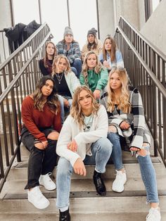 a group of women sitting on top of stairs