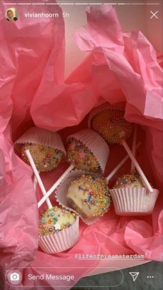 there are many cupcakes in the pink bag