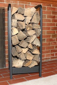 a stack of firewood sitting in front of a brick wall