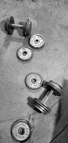 two dumbbells and three weights on the ground