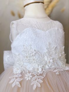 DETAILS: Sweetheart neckline Sheer, lace train Satin bodice with lace overlay 3D floral appliqué at waist Layers of champagne bridal tulle on skirt Matching bow on back Hi-low style Cotton lining Headpiece not included True to size or size up if child is in between sizes Color may vary due to lighting on images PRE ORDER & CUSTOM: Pre orders and custom orders take on average 3-4 weeks to prepare and ship This dress can be custom made up to 12 years Custom orders are Final Sale Please enter the c Zendaya Dress, Serena Dress, Eliza Dress, Pearl Dress, Lace Bodice, Floral Applique, Lace Overlay, Sheer Lace, Gray Dress