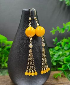 Style Yellow 14K Gold Amber Beeswax Chain Tassel Drop EarringsMade of fine 14K Gold Amber Beeswax Chain Tassel.Measurement: 7.5cm/2.925" * 1.2cm/0.468". Matches easily with daily hairstyle, dresses & Shirts Elegant Latkan Earrings With Round Beads, Elegant Latkans Earrings, Gold Tassel Earrings With Round Beads, Yellow Gold Dangle Tassel Earrings As Gift, Elegant Gold Tassel Earrings With Round Beads, Gold Jewelry With Tassels And Round Beads, Elegant Orange Tassel Earrings For Gift, Elegant Yellow Dangle Tassel Earrings, Elegant Yellow Tassel Earrings For Gift