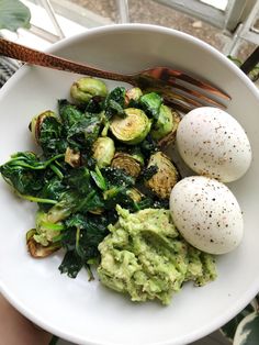 a white bowl filled with vegetables and eggs