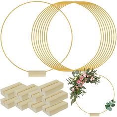 a set of four gold rings with flowers on each side and several pieces of white cardboard