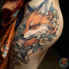 a close up of a woman's thigh with tattoos on her legs and an orange fox