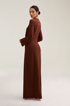 Step into elegance with our Aissia Ribbed Twist Front Maxi Dress. The ribbed fabric and twist front create an elegant design that can be dressed up or down. Perfectly versatile, this dress pairs beautifully with an abaya for a luxurious and sophisticated look. Model is 5'7 wearing size S/58"