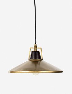 a brass and black pendant light hanging from a ceiling