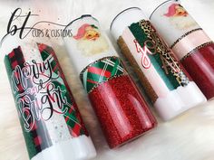 four christmas themed holiday candles are lined up