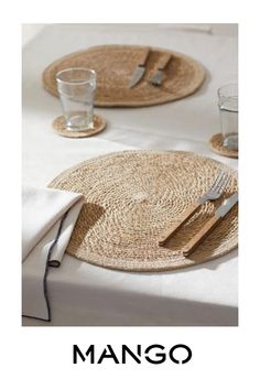 a table with place mats and utensils on it, along with the words mango written in black