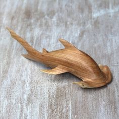 a small wooden toy fish on a table