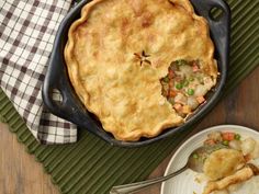 a skillet with some food in it on top of a table next to a plate