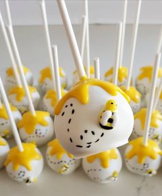 cake pops with yellow and white decorations on them