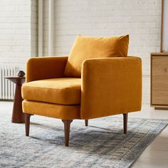 an orange chair sitting on top of a rug