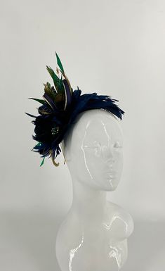 A beautiful elegant navy and gold bespoke handmade feather fascinator, with peacock feathers. Handmade cut feathers with a handmade feather flower designed with navy and gold loops on a gold metal headband. 27cm height x 24cm wide x 9cm wide Blue Feathered Headpiece For Party, Blue Feathered Headband Fascinator, Feather Headband For Royal Ascot, Elegant Blue Headpiece With Feather Trim, Gold Feathered Fascinator For Party, Elegant Gold Fascinator With Feathers, Metal Headband, Fascinator Headband, Feather Fascinators