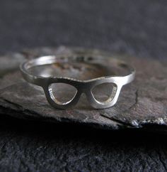 This unique dainty sterling silver ring is handcrafted from 20 gauge sterling silver sheet. The Details ∞ Artisan handmade jewelry ∞ 20 gauge handmade ring band (approx 4.5mm tall at the glasses, 1.2mm band) ∞ Extremely dainty and lightweight ∞ Sterling silver ~ brushed ∞ Choose ring size at checkout ∞ Made to order ∞ Gift box included ∞ Made in the USA There is a charge for the re-sizing of rings, please make sure of your proper ring size before placing your order to avoid a fee if re-sizing is Handmade Modern Sterling Silver Midi Rings, Modern Handmade Sterling Silver Midi Rings, Modern Nickel-free Sterling Silver Midi Rings, Modern Silver Hypoallergenic Stackable Rings, Modern Hypoallergenic Silver Stackable Rings, Modern Handmade Silver Midi Rings, Modern Handmade Stackable Rings For Anniversary, Artisan Jewelry Handmade, Prescott Az